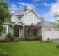 Stock Large classic American house with three car garage.