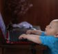 baby using laptop smiling