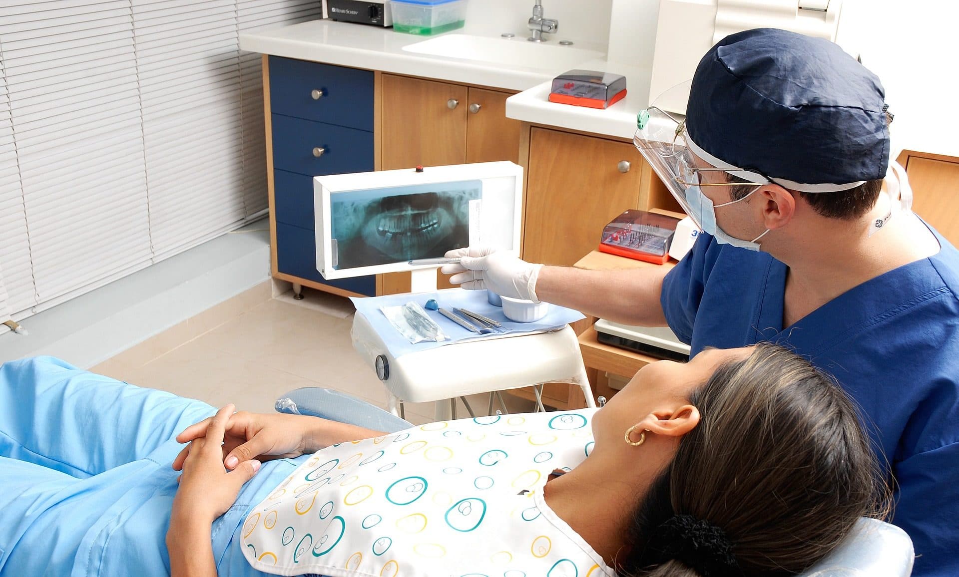 Photo of a dentist discussing x-rays with a patient.
