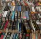 Photo of hundreds of books lined up on a table.